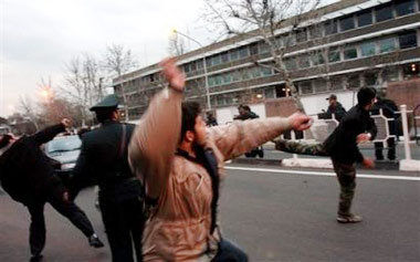 Police killed four people Wednesday as Afghans enraged over drawings of the Prophet Muhammad marched on a U.S. military base in a volatile southern province, directing their anger not against Europe but America.