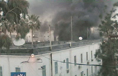 Thick smoke is seen from the top corner of the Italian consulate building in the northeastern city of Benghazi, Libya February 17, 2006. About 10 people were killed and 55 injured in violent clashes between Libyan police and demonstrators on Friday at a protest over cartoons of the Prophet Mohammad, Italian ambassador to Tripoli Francesco Trupiano said.