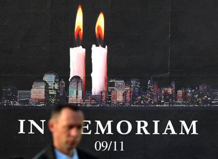 A Kosovo Albanian man walks in front of a poster in Kosovo's capital Pristina September 11, 2006, on the fifth anniversary of the September 11 attacks in the United States.