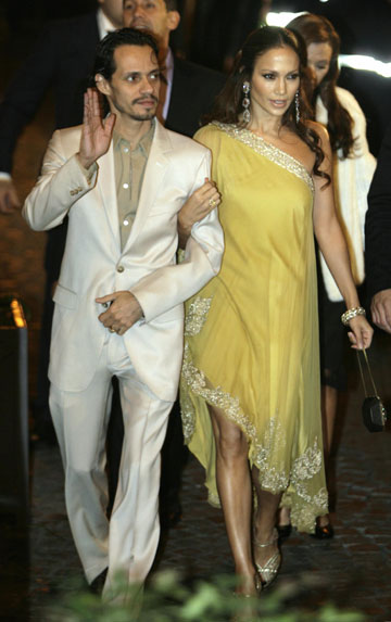 Singer Jennifer Lopez (R) is accompanied by her husband Marc Anthony as they arrive at a restaurant for a party thrown by Tom Cruise and his fiancee Katie Holmes in Rome November 16, 2006.