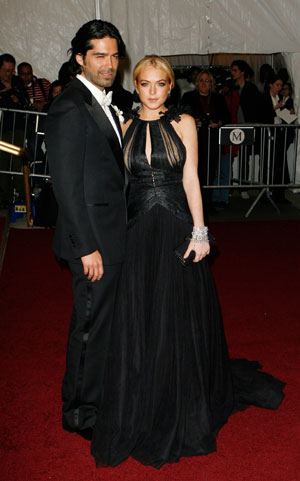 Actress Lindsay Lohan arrives with Brian Atwood to attend the Metropolitan Museum of Art Costume Institute Benefit Gala