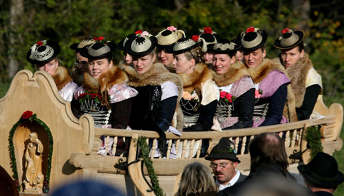 Farmers' wives dressed in traditional Bavarian costume ride in a wooden carriage on the way to the church of Bad Toelz during the Leonhard procession November 6, 2006. The Leonhardi Ritt procession is an annual event that started in the 17th century to pray to St. Leonhard, the patron saint of animals.