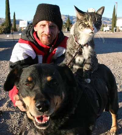 Greg Pike, 43, with his dog Booger, cat Kitty and white mice, all called Mousie, outside his home in Naco, Arizona, December 24, 2006. Picture taken December 24, 2006.