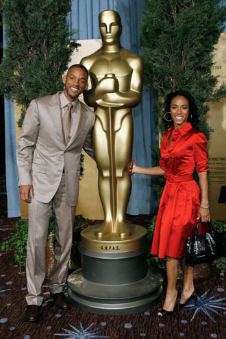 Actor Will Smith (L), nominated for best actor in a leading role for 'The Pursuit of Happyness' and his wife Jada Pinkett-Smith attend the 79th annual Academy Awards nominees luncheon in Beverly Hills California February 5, 2007. The Academy Awards will be given out in Hollywood on February 25.