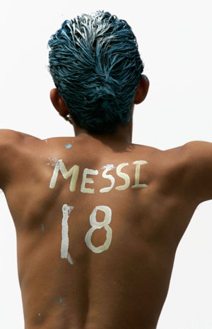 An Argentina fan's back is painted with the words: