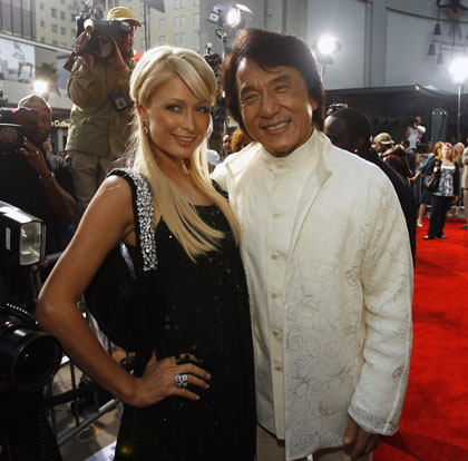 Cast member Jackie Chan (R) poses with Paris Hilton at the premiere of