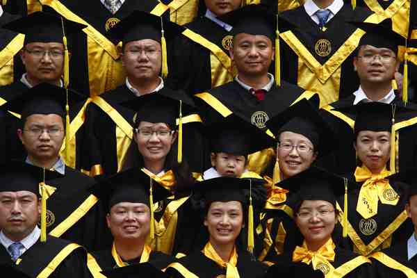 At Renmin University, a doctoral graduate dresses her child in a look-alike gown for the graduation photo. Kuang Linhua / China Daily Ready for the real world