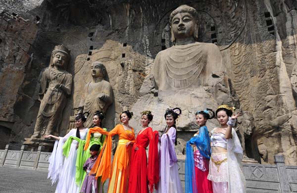 Women dressed up as fairy maidens perform for tourists as part of Qixi celebrations at the Longmen Grottoes scenic spot in Luoyang, Henan province, on Aug 10, 2013. Celebrating Chinese Valentine's Day