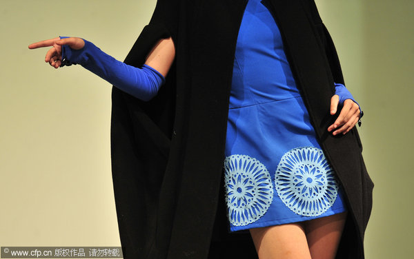 A model wears creations by graduates of Wuhan Textile University in Wuhan, Central China's Hubei province, May 18, 2011. About 50 selected garments from this year’s university graduates were presented in the show, with a diversity of styles from the elegant to the wild. A teacher said a graduation design usually took six months to complete and the finished product showed a student's understanding of nature, society, and life. Fashion graduates show what they’ve got
