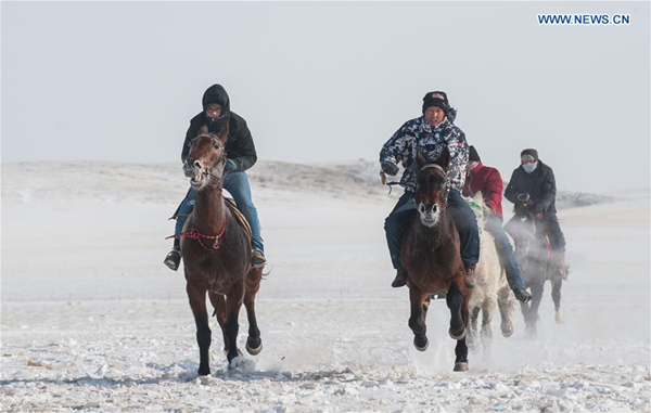 Men ride on horseback during Naadam game in North China