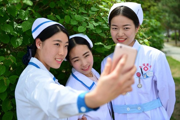 Grinning faces on World Smile Day