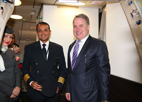 James Hogan, president and chief executive officer of Etihad Airways, takes a photo with some crew on the maiden flight from Abu Dhabi to Shanghai on Thursday. Etihad Airways launches direct flights to Shanghai