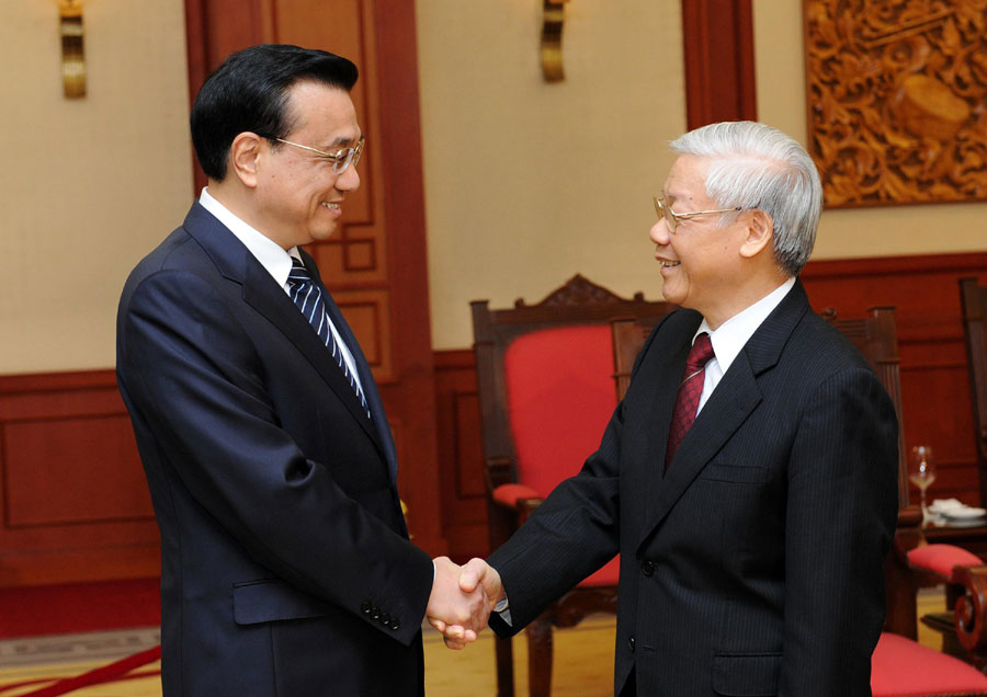 Premier Li Keqiang, left, shakes hands with Vietnamese General Secretary of the Communist Party Nguyen Phu Trong at the Party Central Committee Office in Hanoi, Oct 14, 2013. Highlights: Premier Li Keqiang in Vietnam