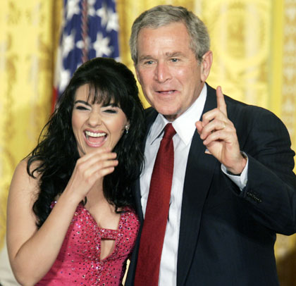 U.S. President George W. Bush requests another song from Latina singer Graciela Beltran during her performance at a Cinco de Mayo celebration in the East Room of the White House in Washington May 4, 2006.