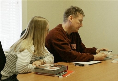 Peter Read of Annandale, VA., and his wife Cathy look at photos of their daughter, Mary Karen Read, during an interview with the Associated Press in Blacksburg, Va., Thursday, April 19, 2007.