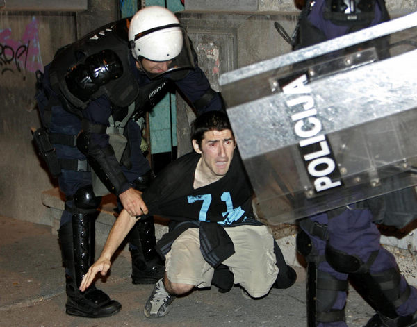 Serbian riot police arrest a protester during riots in Belgrade May 29, 2011. Clashes erupt in Belgrade to protest Mladic arrest