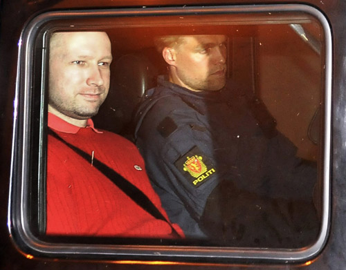 Norwegian Anders Behring Breivik (L), the man accused of a killing spree and bomb attack in Norway, sits in the rear of a vehicle as he is transported in a police convoy as he is leaving the courthouse in Oslo July 25, 2011. A judge ordered eight weeks detention on Monday for Breivik who has admitted a bombing and shooting massacre that killed about 90 people and who claimed in court to have two more groups of collaborators. Custody, in line with prosecutors' request, will allow them to investigate the case against Breivik, 32, an anti-Islamic zealot who has previously claimed sole responsibility for Friday's attacks. The custody can be extended. China Daily, Chinadaily.com.cn Norway mass killer jeered on way to court hearing