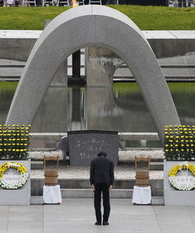 Japan's Prime Minister Naoto Kan bows to a cenotaph dedicated to atomic bomb victims during a ceremony at the Peace Memorial Park in Hiroshima August 6, 2011, on the 66th anniversary of the world's first atomic bombing on the city. Japan's Hiroshima city marks atomic bombing