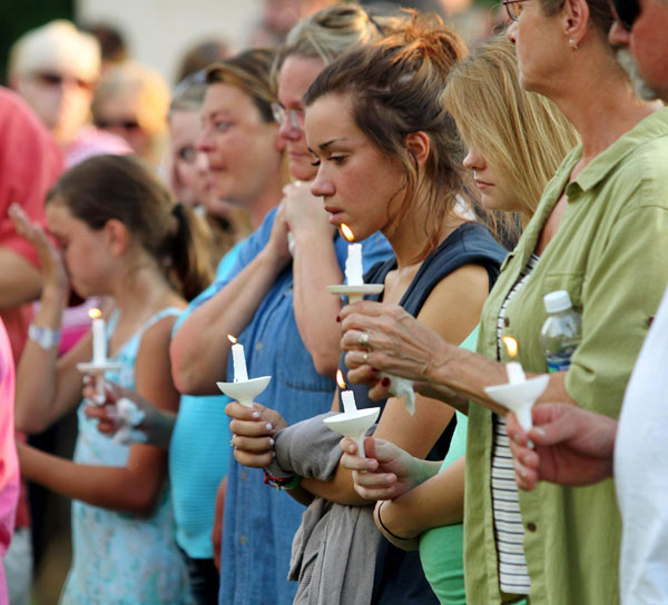Members of the Copley, Ohio community hold a candlelight vigil at Copley Community Park in honor of seven neighbors who were killed August 7, 2011. Seven people, including an 11-year-old, were slain on Sunday before police killed the alleged gunman in a small town near Akron, Ohio, police said. Police: 8 shot to death in Ohio, including child