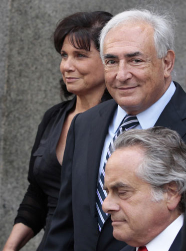 Former IMF chief Dominique Strauss-Kahn and his wife Anne Sinclair depart the Manhattan State Supreme Courthouse after a hearing dismissing the case against him in New York August 23, 2011. Muted response to prospect of Strauss-Kahn return
