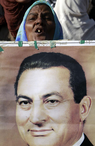 A female supporter of Egypt's former President Hosni Mubarak shouts slogans outside the police academy where his trial will take place in Cairo December 28, 2011. Egypt's Mubarak returns to court