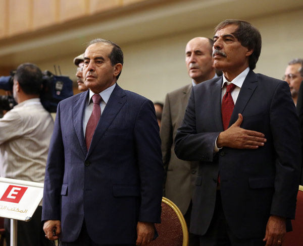 Mahmoud Jibril (left), Libya's interim prime minister during last year's war and now head of the National Forces lliance, and Dr Ali Altarhuni, centrist National Movement head, stand during the transfer of authority ceremony in Tripoli on Wednesday. MAHMUD TURKIA / AGENCE FRANCE-PRESSE Libya’s ruling council hands over power