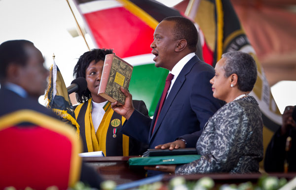 President-elect Uhuru Kenyatta holds the Bible as he takes the oath as the president of Kenya in Nairobi on Tuesday. Ben Curtis / Associated Press Kenyatta takes reins in Nairobi