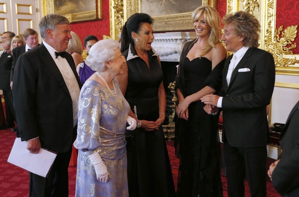 Britain's Queen Elizabeth (2nd left) speaks to Penny Lancaster (2nd right) and Rod Stewart (right) during a reception for the Royal National Institute for the Blind at St James Palace, in central London June 3, 2013. Queen Elizabeth to mark six-decade reign