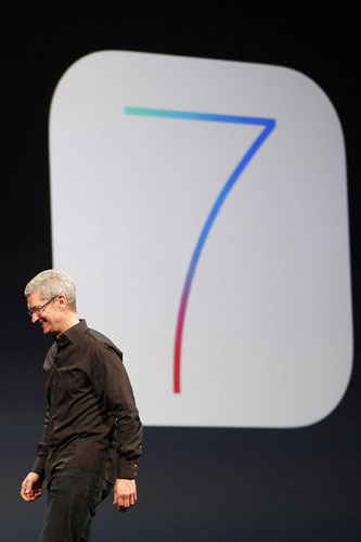 Apple Inc. CEO Tim Cook walks past an iOS7 logo during the Apple Worldwide Developers Conference (WWDC) 2013 in San Francisco, California June 10, 2013. Apple unveils new mobile software platform