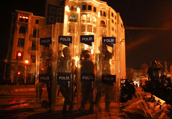 Riot policemen stand guard in Istanbul's Taksim square June 11, 2013. Turkey police storm protest square in new clashes