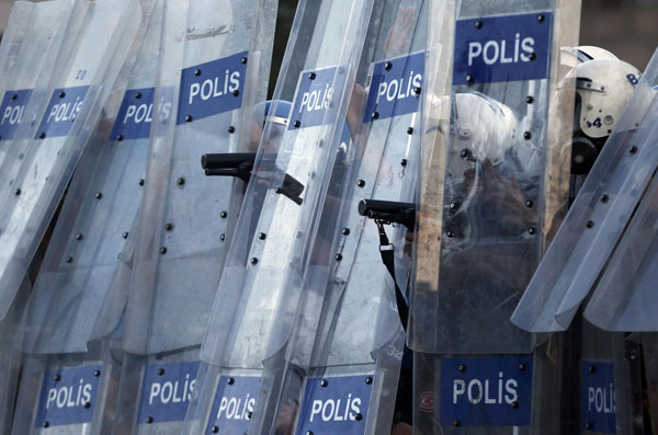 Riot policemen prepare to fire teargas during a protest at Taksim Square in Istanbul June 11, 2013. Turkey police storm protest square in new clashes