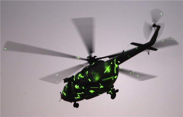 A military helicopter flies above Tahrir Square while protesters opposing deposed Egyptian President Mohamed Morsi shout slogans against him and the Muslim Brotherhood during a protest, in Cairo, July 7, 2013. Huge crowds rally in Egypt, political talks stalled
