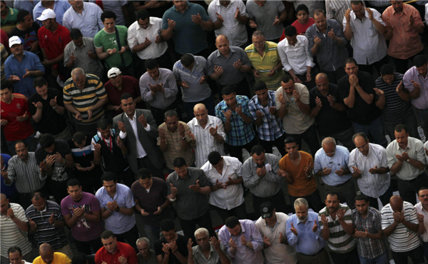 Protesters who are against deposed Egyptian President Mohamed Morsi perform evening prayers during a protest at Tahrir square in Cairo, July 7, 2013. Huge crowds rally in Egypt, political talks stalled