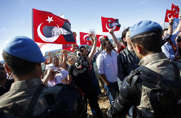 Protesters are blocked by Turkish soldiers as they try to march to a courthouse in Silivri, where a hearing for people charged with attempting to overthrow Prime Minister Tayyip Erdogan's Islamist-rooted government is due to take place August 5, 2013. Turkish court will pass judgment on Monday on nearly 300 defendants accused of plotting to topple the government in a battleground case in the decade-long conflict between Prime Minister Tayyip Erdogan and Turkey's secularist establishment. Security forces set up barricades around the courthouse in the Silivri jail complex, west of Istanbul, to tighten security after the defendants' supporters vowed to hold a demonstration against the five-year trial that has exposed deep divisions in Turkish society. Turkish police clash with protesters over coup trial
