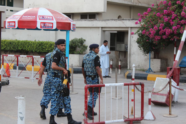 A security squad guards the entrance to Islamabad International Airport. Pakistanis adapt to everyday heightened security