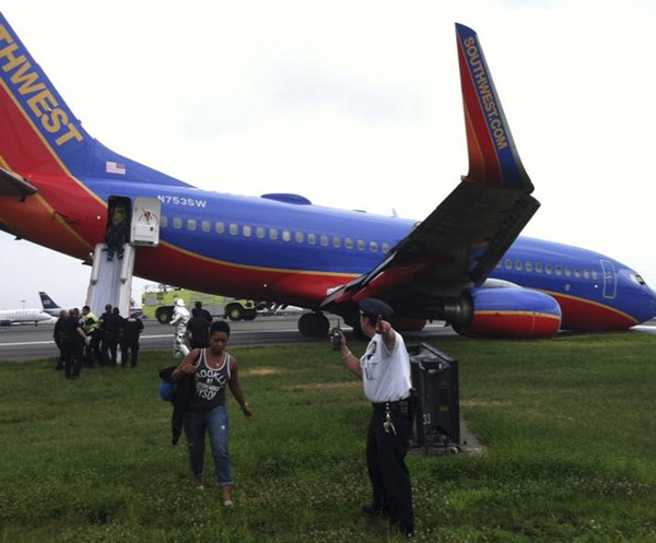 A Southwest Airlines plane sits on the tarmac as passengers disembark at LaGuardia airport in New York, July 22, 2013, in this photo courtesy of @mattjfriedman and Frank Ferramosca. Capt took control 120m above ground in accident