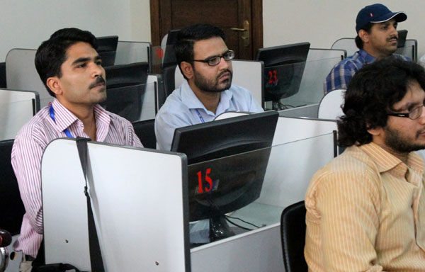 Shameel Farhan (left), a 39-year-old Pakistani security officer, attends a Mandarin course at the National University of Modern Languages in Islamabad in June. Mandarin becomes priority