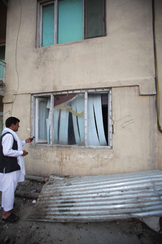 The broken window of the room is seen where three Chinese and an Afghan were killed Thursday by unknown armed people in Kabul, Afghanistan, on Aug 9, 2013. One missing Chinese found safe in Afghanistan