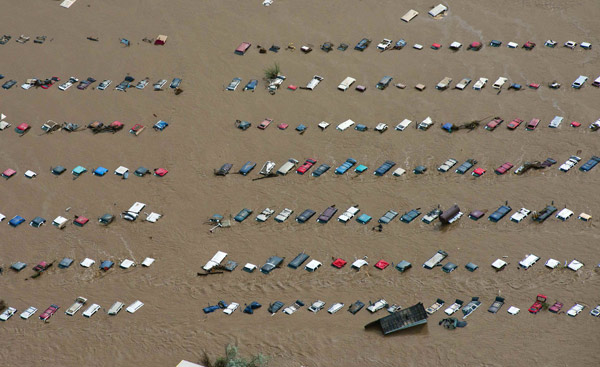 An aerial view of vehicles submerged in floodwaters along the South Platte River near Greenley, Colorado, on Saturday. Rescuers search for Colorado flood victims